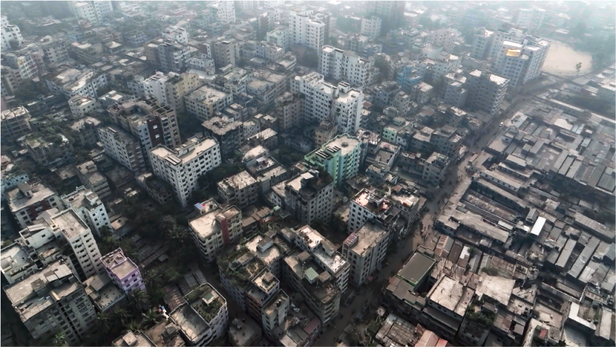 An aerial photograph of a neighbourhood in Dhaka, showing high rise buildings.